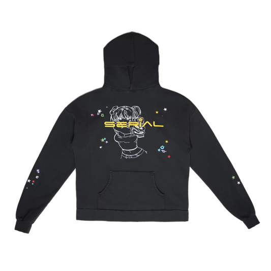 Black hoodie featuring a graphic of a person holding a gun, surrounded by colorful stars, with the text 'SERIAL' in bold yellow across the back.